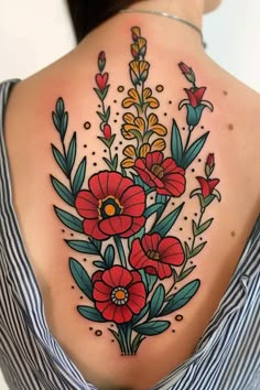 a woman with a flower tattoo on her back