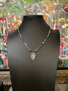 Beautiful super colorful beaded necklace with sacred heart pewter pendant. UNISEX, BOHO.  Versatile can be worn dressy or with jeans and a t-shirt.absolutely delightful!  Made to order, will send photo of your necklace before ship for your approval. 😃 EACH NECKLACE WILL BE SLIGHTLY DIFFERENT, BUT WITH SAME BEAD MIX. Will send you a picture of final necklace for your approval. Bead mix may include: Ancient Djenne beads, ancient African trade beads, ancient Roman glass beads, Labradorite, faceted Nickel Free Multicolor Bohemian Beaded Necklaces, Bohemian Multicolor Nickel-free Beaded Necklaces, Nickel Free Multicolor Beaded Necklace For Festivals, Nickel-free Multicolor Beaded Necklace For Festival, Spiritual Multicolor Pendant Beaded Necklaces, Spiritual Multicolor Beaded Pendant Necklace, Spiritual Multicolor Pendant Beaded Necklace, Silver Amulet Necklace With Colorful Beads, Multicolor Spiritual Beaded Necklaces Nickel Free