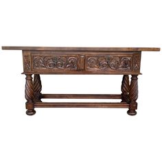 an old wooden table with carvings on the top and bottom, against a white background