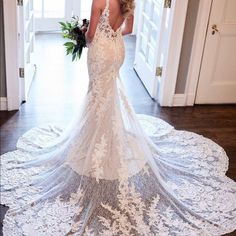 a woman in a wedding dress standing on a rug