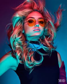 a woman with bright hair and sunglasses on