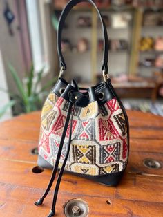 Thank you for visiting our shop!  It's very useful bag as shoulder and as crossbody bag.  This bag is spacious and holds a lot of things. Size         : 30cm x 27cm x 8cm Material  : wool / leather We select beautiful vintage kilims from all over the anatolian area and middle east area. and We do special wash for Kilim rug first, after that cut the kilim to remake unique kilim bags at our atelier  one by one. All products have been produced in a smoke-free environment.  Vintage kilim with colore Everyday Crossbody Hobo Bag With Leather Handles, Multicolor Everyday Bucket Shoulder Bag, Daily Leather Handles Crossbody Shoulder Bag, Daily Leather Handle Crossbody Shoulder Bag, Everyday Multicolor Bucket Shoulder Bag, Everyday Leather Handle Crossbody Bucket Bag, Everyday Bucket Hobo Bag With Detachable Strap, Everyday Bucket Satchel With Leather Handles, Everyday Use Hobo Bag With Detachable Strap