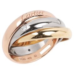 Cartier Diamond Set 18ct White Gold, 18ct Yellow Gold And 18ct Rose Gold Medium Trinity Ring Brand- Cartier Model- Diamond Set Medium Trinity Ring Product Type- Ring Serial Number- ZJ**** Accompanied By- Cartier Box Material(s)- 18ct White Gold, 18ct Yellow Gold, 18ct Rose Gold Gemstone- Diamond UK Ring Size- J EU Ring Size- 49 US Ring Size- 5 Resizing Possible- No Gemstone Quantity- 5 Gemstone Cut- Round Brilliant Gemstone Carat Weight- 0.06ct Band Width- 3.4mm Total Weight- 9.4g Model Number- B4236452 Condition Rating- Excellent Condition Notes- An item rated as excellent exhibits minimal to light signs of use. Cartier Diamond, Trinity Ring, Diamond Set, Gold Set, Lighted Signs, Round Brilliant, Cartier, Or Rose, Fashion Rings