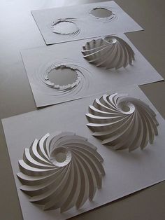 three pieces of paper cut out to look like spirals