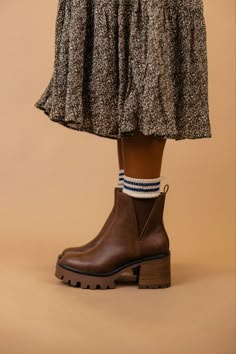 The Rusty is a dark brown bootie featuring a 3" heel and a small platform. Take inspo from our pictures and pair with your favorite boot socks and a floral dress! 3 1/4" heel; 1/2" platform 9 1/4" shaft; 10 1/2" calf circumference Contoured footbed Synthetic upper and lining/rubber sole *FINAL SALE* Brown Platform Boots With Lug Sole For Winter, Brown High Heel Chelsea Boots With Medium Width, Brown Chunky Platform Boots With Round Toe, Brown High Heel Chelsea Boots Medium Width, Brown High Heel Chelsea Boots, Brown Chelsea Boots With Stacked Heel For Fall, Brown Heeled Boots With Lug Sole And Round Toe, Brown Lug Sole Platform Boots For Fall, Fall Brown Platform Boots With Lug Sole