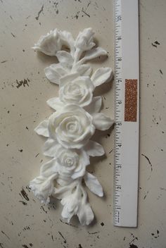 white flowers are placed next to a ruler