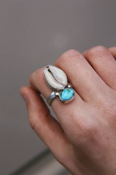 Cowrie Shell and Turquoise Stone Ring, Sterling Silver Statement Ring, Coastal Cowgirl Jewellery, Cowrie Shell Jewellery, Eco Handmade Jewellery Handcrafted one of a kind statement ring, using a large cowrie shell and a beautiful sonoran gold turquoise stone.  Ring Size - UK P 1/2 All Dreamgazer Designs treasures are created by hand with love, energy and time, making each piece similar however unique to itself and therefore no two are the exact same.  For sizing check our ring size page. Estilo Pinterest, Cowrie Shell Jewelry, Turquoise Stone Ring, Shell Jewellery, Coastal Jewelry, Summer Jewellery, Cowry Shell, Ring Inspo, Rustic Rings