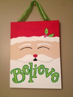 a paper bag hanging on the wall with santa claus's face painted on it