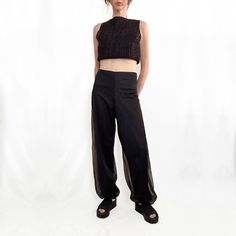 These true vintage black chiffon pants are perfect for Summer nights out. Likely made in the 70s from a lightweight, opaque nylon overlaid with a sheer chiffon nylon fabric, exuding a delicate and airy vibe. Featuring a high-waisted fit with slightly stretchy waistband these pants offer a sleek, smooth waist with relaxed, loose fit legs, tapering slightly toward gathered cuffs at the ankles, creating a romantic subtle blousy bubble effect. Blending vintage harem pant influences with a modern min Chic Sheer Mesh Bottoms, Chic Mesh Bottoms For Evening Wear, Chic Mesh Bottoms For Evening, Sheer Nylon Chic Bottoms, Chic Sheer Nylon Bottoms, Chic Mesh Bottoms For Party, Chic Party Bottoms In Mesh, Sheer High-waist Nylon Bottoms, Evening Mesh Bottoms With Stretch