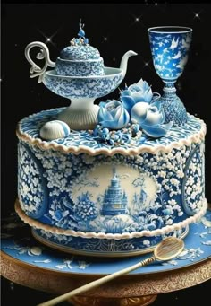 a blue and white cake sitting on top of a table next to a bowl with spoons