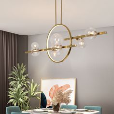 a dining room table with blue chairs and a gold chandelier