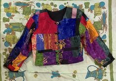 "This listing is for a vintage 1980s 1990s lightweight multi-color patchwork quilted crop jacket. This jacket is so great and is in very good vintage condition! Jacket is lightweight but is lightly quilted and has a great multi color patchwork design with gold toned metal toggle style or frog style buttons. Jacket has long sleeves and front patch pockets. Jacket shows just minor wear, nothing to note! No tags. Please check measurements for accuracy. Measurements: (please double where appropriate Bohemian Jackets, Lightweight Quilt, Patchwork Designs, Cropped Jacket, Crop Jacket, Boho Bohemian, Vintage Outfits, Multi Color, Jackets & Coats