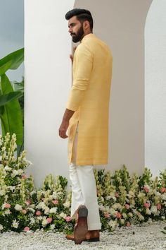 Yellow placed floral thread and cutdana embroidered kurta with mirrorwork. Comes with bell bottom pant.
Components: 2
Pattern: Embroidered
Type Of Work: Thread, Cutdana
Neckline: Mandarin Collar
Sleeve Type: Full
Fabric: Kurta: Raw Silk, Bellbottom: Cotton Silk
Color: Yellow
Other Details: 
Closure: Kurta: Front button
Occasion: Sangeet,Mehendi and Puja - Aza Fashions Long Cotton Kurta For Eid, Long Cotton Traditional Wear For Festive Occasions, Yellow Raw Silk Kurta With Dabka Detailing, Yellow Raw Silk Kurta With Dabka, Designer Slub Silk Sherwani With Traditional Drape, Traditional Straight Kurta For Puja, Long Raw Silk Kurta With Resham Embroidery, Cotton Long Kurta For Festivals, Bollywood Style Straight Kurta Sherwani In Slub Silk