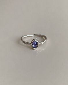 Introducing our Handcrafted Blue Tanzanite Silver Ring, a unique piece designed for individuality and elegance. This one-of-a-kind ring seamlessly combines the timeless allure of silver with the captivating beauty of Tanzanite. Tanzanite, known for its vibrant blue hue, is a gemstone associated with spiritual awareness and clarity. It is believed to promote inner wisdom and inspire a sense of calmness. Each ring is crafted as a singular piece, making it exclusive and distinctive. Embrace the enc Silver Tanzanite Jewelry For Wedding, Oval Tanzanite Halo Jewelry, Silver Tanzanite Wedding Jewelry, Elegant Blue Gemstone Stackable Rings, Elegant Sapphire Moonstone Ring As Gift, Elegant Blue Stackable Birthstone Rings, Elegant Blue Birthstone Stackable Rings, Tanzanite Halo Promise Ring, Elegant Silver Sapphire Ring In Sterling Silver