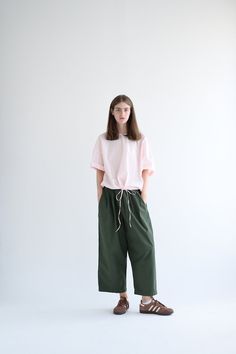 Manuelle Guibal Dandy Pant in color Military Road. Featuring an elastic waistband, pleats at front, pockets at sides and on back, ankle length, wide straight leg fit. 0 (Xsmall) - waist (before stretching elastic) - 22.5", length - 35" 1 (small) - waist (before stretching elastic) - 25", length - 35.5" 2 (medium) - waist (before stretching elastic) - 26.5", length - 36"3 (large) - waist (before stretching elastic) - 28", length - 36.5" 100% Cotton, Made in France. Relaxed Fit Wide Leg Bottoms With Pleated Waist, Relaxed Fit Bottoms With Pleated Waist And Wide Leg, Versatile Spring Parachute Pants With Tapered Leg, Spring Relaxed Fit Tapered Leg Parachute Pants, Versatile Tapered Leg Parachute Pants For Spring, Casual Workwear Culottes With Elastic Waistband, Green Wide Leg Pants For Daywear, Spring Workwear Bottoms With Boxy Fit, Relaxed Fit Wide-leg Pants With Pleated Waist