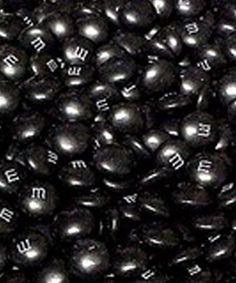 many black balls with white letters on them are shown in this close up photo,