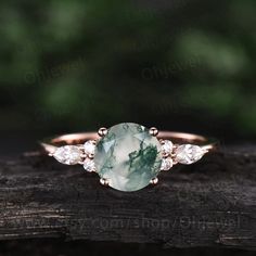 "This is a moss agate engagement ring in solid gold,about 7mm round cut. The accent stones are round 1.5mm and marqueise 2x4mm moissanites. It can be made in any ring size. However please contact me to custom make it to a special big or small size. It can be made in white gold,rose gold or yellow gold with 14k or 18k. However for some people who are nickel allergic,I can also make it to 925 sterling silver to make you can wear it. The ring is handmade,very high quality! 30 days money back guaran Dainty Emerald Jewelry For Promise, Timeless Rose Gold Moissanite Jewelry, Timeless Moissanite Rose Gold Jewelry, Cubic Zirconia Gemstone Jewelry For Promise, Cubic Zirconia Promise Jewelry With Gemstone, Heirloom Rose Gold Jewelry With Prong Setting, Fine Jewelry With Bezel Setting For Promise, Delicate Rose Gold Moissanite Jewelry, Elegant Moissanite Promise Ring Jewelry