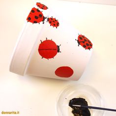 a coffee cup with ladybugs painted on it