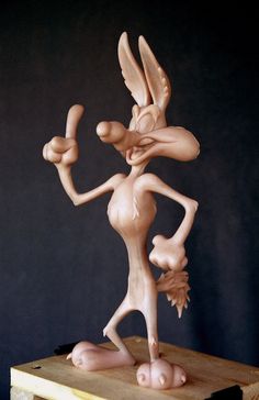 a wooden sculpture of a cartoon character on a table