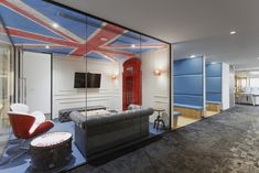 an office with a british flag painted on the wall and blue upholstered walls