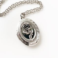 "Rose Locket Necklace Silver Photo Locket Floral Jewelry -I make this necklace using an antique silver chain and locket and rose -Pick any chain length from the dropdown menu- if you don't see your desired length, select \"custom\" and leave the length you need in the \"note to seller\" at checkout -The locket measures 1 3/8\" tall x 1\" across closed. with space for two photos inside -Nickel free and lead free alloy metal -Gift Boxed More of my Rose Jewelry: https://www.etsy.com/shop/lydiasvint Rose Locket, Locket Necklace Silver, Silver Locket Necklace, Mom Wedding Gift, Cameo Jewelry, Floral Jewelry, Wedding Gifts For Bridesmaids, Cameo Necklace, Rose Jewelry