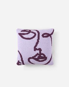 a purple pillow with a face drawn on it