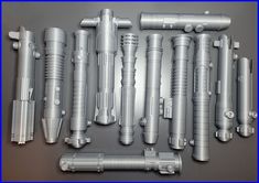 many different types of metal pipes and fittings on a gray surface with blue border