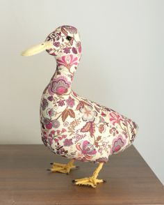 a wooden duck sitting on top of a table