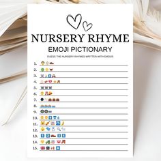 a sign that says nursery rhyme emojtionary on top of some feathers