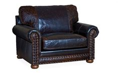 a brown leather chair with studding on the armrests and foot rests against a white background