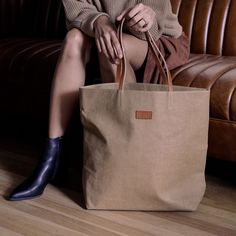 Designed to take you everywhere, meet the must-have, double-handled tote bag that you'll reach for season after season. With a generously spacious interior, this bag is your go-to for work, play, kids and travel and will keep you looking chic and put together. Lightweight and sustainably made, you won't want to leave home without it. Brown Coated Canvas Travel Bag With Handles, Eco-friendly Shoulder Bag With Rolled Handles For Travel, Large Capacity Coated Canvas Satchel With Double Handle, Large Capacity Coated Canvas Bucket Bag For Shopping, Large Capacity Coated Canvas Bag With Double Handle, Large Capacity Coated Canvas Bag For Shopping, Rectangular Shopping Bag With Rolled Handles, Brown Coated Canvas Bucket Bag Tote, Brown Coated Canvas Tote Bucket Bag