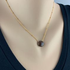 "Smoky Quartz Pendant Simple Necklace Minimalist Necklace Necklace for Women Gemstone Necklace Layering Necklace Dainty Necklace Gift for Her Appearing to float, the bold brownish grey Smoky Quartz balances perfectly on this delicate Satellite Chain. We have threaded the chain through the stone for extra drama. The chain is finished with delicate Smoky Quartz Rondels at the closure and end of the two inch extension. Our Smoky Quartz Pendant is a perfect day to night piece that needs little intro Minimalist Gemstone Pendant Crystal Necklace, Minimalist Birthstone Crystal Necklaces For Jewelry Making, Minimalist Crystal Necklace As Gift, Minimalist Crystal Necklaces With Round Natural Stone Pendant, Minimalist Crystal Necklace With Round Natural Stone Pendant, Minimalist Round Pendant Crystal Necklace With Gemstone, Minimalist Crystal Necklace With Round Pendant, Minimalist Crystal Necklace With Round Gemstone Pendant, Minimalist Crystal Birthstone Necklaces