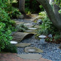 a stone path surrounded by trees and rocks