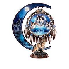 a clock with three wolfs on it and the moon in the sky behind it