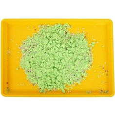 a yellow tray with green powder on it