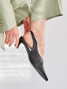 - Pointed toe- Wave upper line- Slingback strap- Mid heelMeasurements- Heel: 1.9in- Size: KR225(US5.5)-255(US8.5)- This item is based on the KR shoe size. Please refer to the size chart.Composition- Upper: Sheepskin- Lining: Synthetic LeatherDesigner- Made in Korea- by MEIEL DEW- Style#: 300923418 Black Low Heel Slingback Pumps With Heel Loop, Pointed Toe Mules With Heel Strap For Office, Sleek Slingback Kitten Heels With Padded Heel, Open Heel Slingback Sandals With 4-inch Heel For Work, Classic Black Slingback Mules, Sleek Pointed Toe Mules With Heel Loop, Formal Pointed Toe Mules With Heel Loop, Black Slingback Sandals With Sculpted Heel, Sleek Slingback Pumps With Padded Heel