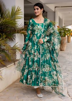 PRODUCT DESCRIPTION :-Flaunt the traditional Aesthetics with this beautiful bottle green floral printed tier pattern Anarkali . It is all set to steal the hearts with it`s pretty print and details.Anarkali :- chanderi cottonPant :- CottonDupatta :- Organza silkClosure Used:- Side zipColor:-Anarkali and dupatta - bottle green Pant - off whiteCare Instructions :- Dry clean onlyModel Size :- Model is wearing XS sizeModel Height :- 5.6''DISCLAIMER :- Slight color variations may occur due to differen Green Floral Sharara For Navratri, Bollywood Anarkali Set With Floral Print, Bollywood Style Green Floral Sharara, Green Bollywood Style Sharara With Floral Print, Green Anarkali Set With Printed Motifs And Maxi Length, Green Bollywood Anarkali Set With Printed Motifs, Green Floor-length Anarkali Set With Printed Motifs, Transitional Season Green Salwar Kameez In Maxi Length, Green Printed Sharara For Wedding