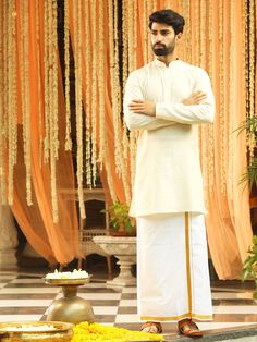 Vastramay Men Cream Pure Cotton Kurta with Mundu Cream Cotton Silk Kurta With Traditional Drape, Traditional Off-white Kurta With Naqshi, Traditional Off White Kurta With Naqshi, Traditional Cotton Kurta With Naqshi, Cream Cotton Silk Kurta For Eid, Cotton Silk Sherwani With Chikankari Embroidery For Puja, White Cotton Silk Sherwani With Dabka, Ceremonial Cotton Sherwani With Cutdana, White Cotton Silk Sherwani For Festivals