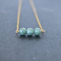 One of our most popular necklace styles now in gorgeous jade! Three small 6mm beads on your choice of sterling silver or gold filled chain. Jade has many benefits! - A stone of good luck and fortune - Soothing and calming stone that promotes harmony and balance in friendships, family and work. - Promotes confidence and self sufficiency - Releases negative energy and promotes emotional and spiritual healing. Minimalist Jade Gemstone Jewelry, Elegant Round Amazonite Necklace, Amazonite Round Beads Necklace For Gift, Minimalist Jade Round Pendant Necklace, Jade Birthstone Necklace For May, May Jade Birthstone Necklace, Elegant Amazonite Necklace For Gift, Elegant Everyday Amazonite Jewelry, Minimalist Green Necklaces For Jewelry Making