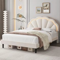 a white bed with an upholstered headboard and foot board in a bedroom