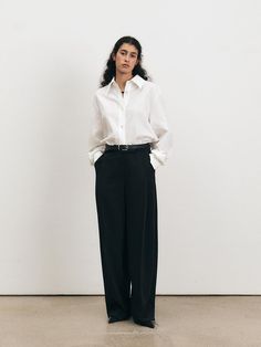 This Over Fit Shirt exemplifies modern minimalism with its oversized silhouette and crisp tailoring. The structured collar and clean button placket provide a timeless look, while the relaxed fit adds a contemporary edge. It's an ideal choice for those who favor a sophisticated yet unfussy aesthetic in their wardrobe. - The Over Fit Shirt is made from a breathable fabric, perfect for all-day comfort.- Its generous cut ensures ease of movement and a laid-back vibe.- The shirt's long sleeves and buttoned cuffs can be styled rolled up or down to suit different looks.- This versatile shirt can be paired with fitted trousers for contrast or worn with other loose garments for a fully relaxed ensemble. Timeless Wide Leg Pants For Workwear In Spring, Timeless Wide-leg Dress Pants For Office, Timeless Tailored Wide Leg Office Pants, Timeless Tailored Wide Leg Pants For Office, Classic Wide Leg Workwear Pants, Classic Wide Leg Dress Pants With Relaxed Fit, Classic Wide Leg Pants With Straight Hem For Work, Classic Wide Leg Trousers For Workwear, Elegant Wide Leg Pants For Workwear With Straight Hem