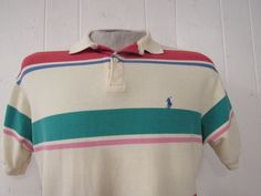 "Vintage 1980s or 90s color block striped cotton polo shirt. Made in the U.S.A. by Polo Ralph Lauren. Has embroidered Polo horse and jockey on chest. Size medium. Actual measurements are: 43\" at the chest 42\" at the waist 18.5\" shoulder seam to shoulder seam 31\" overall length In very good condition." Casual Multicolor Polo Shirt With Striped Collar, Casual Striped Polo Shirt, Retro Cotton Polo Shirt With Striped Collar, Retro Striped Polo Shirt With Polo Collar, Retro Striped Polo Shirt, Multicolor Cotton Polo Shirt With Striped Collar, Vintage White Cotton Polo Shirt, Vintage Striped Polo Collar Tops, Vintage Green Polo Shirt With Polo Collar