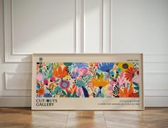 a box with an image of colorful flowers on the front and side, sitting on top of a hard wood floor