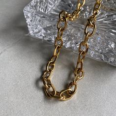 A trendy chunky link chain to elevate your stack. Chunky Link Necklace Length: 17" plus a 2" extension chain attached Width: 11mm Material: Stainless Steel Plating: 18k real gold Necklace is 100% nickel-free and cadmium-free Necklace is hypoallergenic and tarnish resistant Trendy Gold-tone Link Chain Necklace, Modern Chunky Chain Link Jewelry, Modern Chunky Link Chain Necklace, Gold-tone Chunky Chain Necklace For Gift, Modern Necklace With Chunky Chain Links, Trendy Gold Plated Chain Link Necklace, Chunky Oval Link Necklace As A Gift, Minimalist Cuban Link Chunky Chain Necklace, Modern Necklaces With Chunky Chain