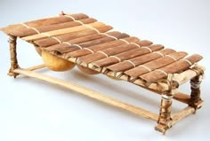 a wooden bench made out of wood sticks