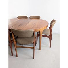 a wooden table with four chairs around it