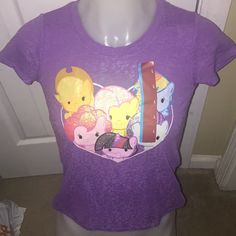 a women's purple tshirt with cartoon characters on it