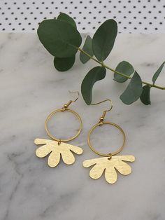 Brass hoop earrings with gold plated hooks. 3.4cm x 1.8cm brushed brass flower shapes sitting on 2.5cm brass hoops with gold plated hooks. Postage: All jewellery items are posted by 1st class recorded delivery with Royal mail, so that you are able to track your order. UK : FREE INTERNATIONAL : £8.00 Brass Flower Earrings, Gold Metal Earrings With Flower Shape, Metal Drop Earrings With Flower Charm, Handmade Gold Metal Flower Earrings, Nickel Free Brass Flower Earrings, Gold Metal Earrings With Flower Charm, Handmade Gold Plated Flower Earrings, Gold Metal Earrings In Flower Shape, Gold Hoop Earrings With Flower Charm For Gift