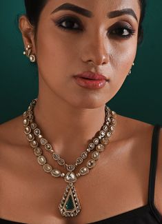 A Kundan royal set featuring a green-centred stone is a beautiful embodiment of traditional Indian jewelry, often associated with regal Rajwada style. This set typically showcases intricate Kundan work, with the centerpiece surrounded by smaller stones, all set in gold or gold-plated metal. The rich green stone adds an eye-catching focal point, enhancing the set's opulence with matching earrings. This necklace measures 22 inches Composition : Mixed Metal with other Semi Precious Stones Care: Keep away from water and perfume Delivery : 2-4 weeks as the product is hand crafted. For more information and sizes please contact fabiliciousfashion@gmail.com or visit our Copenhagen studio. About the Designer : Zaza by Somya is a thoughtfully curated collection of bold yet feminine jewelry pieces. H Bollywood Meenakari Jewelry Sets For Formal Occasions, Bollywood Style Meenakari Jewelry Set For Formal Occasions, Formal Meenakari Jewelry Sets For Diwali, Temple Style Formal Kundan Necklace, Regal Diamond Jewelry For Formal Occasions, Regal Diamond Wedding Jewelry, Kundan Chandbali Temple Necklace For Formal Occasions, Kundan Chandbali Temple Necklace For Formal Events, Formal Kundan Chandbali Temple Necklace