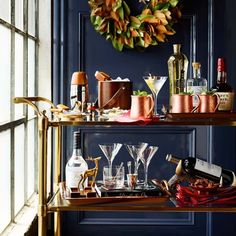 a bar cart filled with drinks and glasses